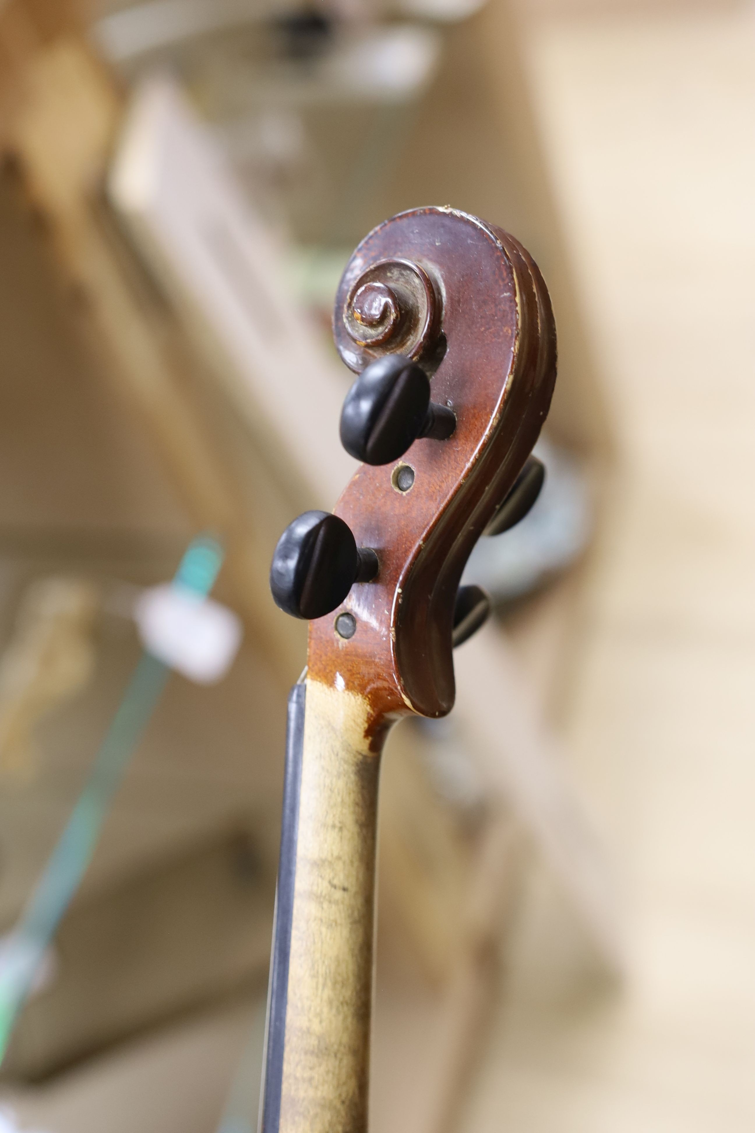 A cased violin, with bow